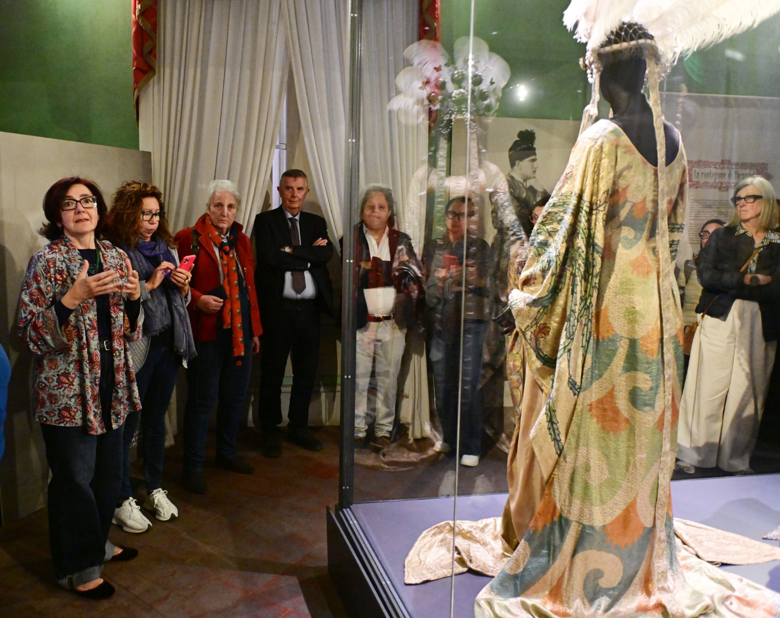 196 Visitors on a guided tour of the Puccini Museum in Lucca observe the Turandot stage costume on display.