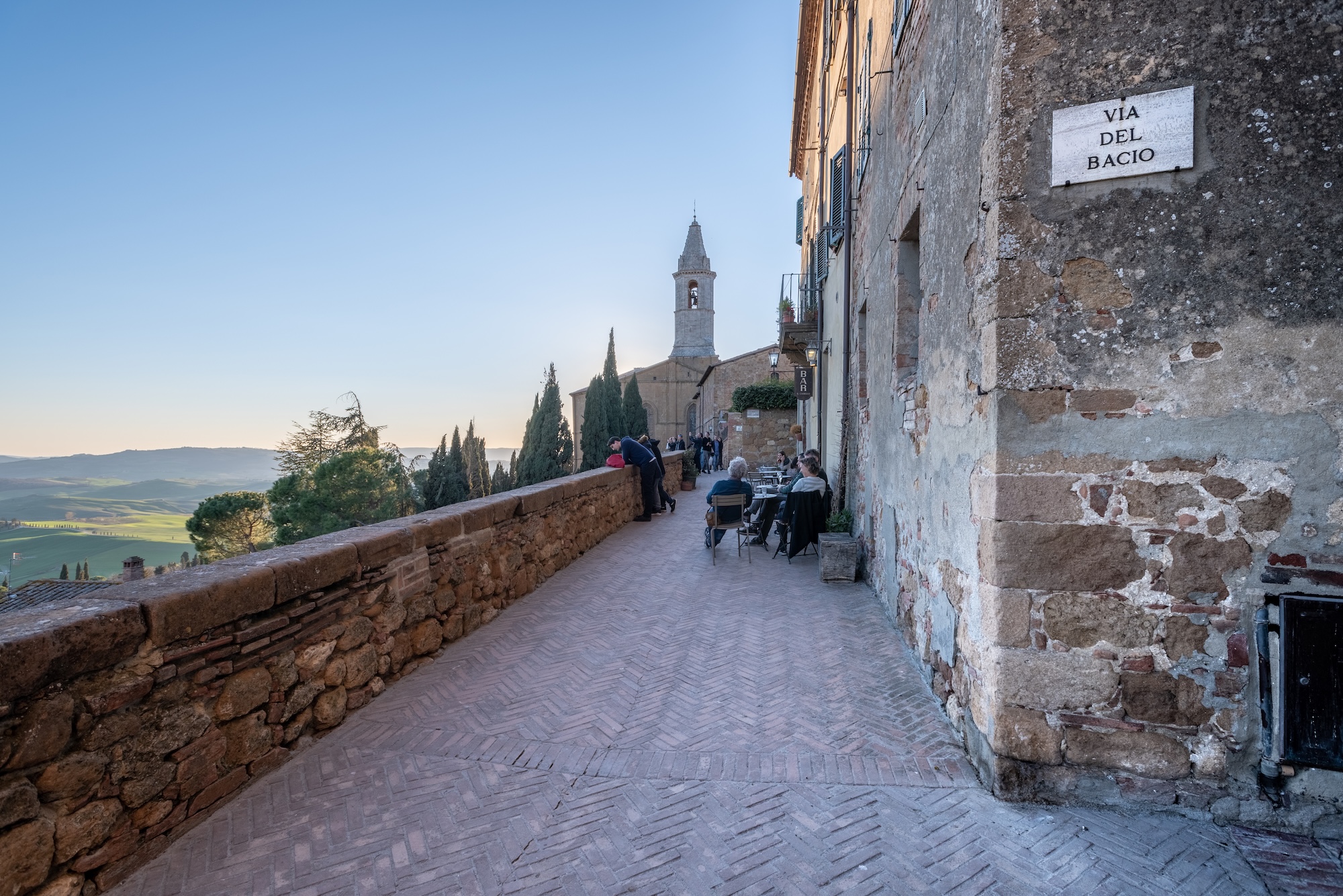 Pienza, a scenic road through the historic center with a view of the Val d’Orcia countryside.