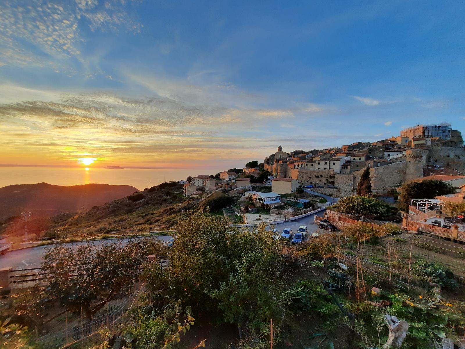 The sunset behind the village perched on the island